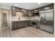 Modern kitchen with stainless steel appliances, sleek countertops, and ample cabinet space at 6448 Ingalls Ct, Arvada, CO 80003