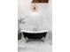 Elegant clawfoot bathtub under a unique chandelier in a bright and modern bathroom at 7225 Box Canyon Rd, Sedalia, CO 80135