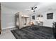 Stylish bedroom featuring a wooden bunk bed, desk area, modern rug, and natural light from two windows at 7225 Box Canyon Rd, Sedalia, CO 80135