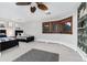 Spacious bedroom with two beds, three windows with wood frames, and unique zebra-themed accent wall at 7225 Box Canyon Rd, Sedalia, CO 80135