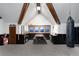 Spacious bonus room featuring exposed wood beams, a climbing rope, and a view from the windows at 7225 Box Canyon Rd, Sedalia, CO 80135