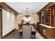 Charming dining room featuring a stone accent wall, wine rack, and elegant dark wood table and chairs at 7225 Box Canyon Rd, Sedalia, CO 80135