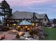 Beautiful home featuring an outdoor patio, fire pit, and enclosed sun room at 7225 Box Canyon Rd, Sedalia, CO 80135