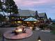 Custom home with a stone patio, fire pit, and enclosed sun room at 7225 Box Canyon Rd, Sedalia, CO 80135