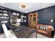 Elegant home office featuring custom bookshelves, a comfortable leather chair, and wood French doors at 7225 Box Canyon Rd, Sedalia, CO 80135