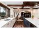 Open kitchen featuring marble countertops, custom cabinets, stainless appliances, and access to dining area at 7225 Box Canyon Rd, Sedalia, CO 80135