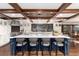Spacious kitchen with a large island, custom cabinets, stainless steel appliances, and beautiful wood beam ceiling at 7225 Box Canyon Rd, Sedalia, CO 80135