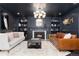 Sophisticated living room featuring a fireplace, custom built-ins, and stylish furnishings at 7225 Box Canyon Rd, Sedalia, CO 80135