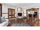 Inviting living room with a cozy fireplace, elegant wood trim, and an open layout connected to the kitchen at 7225 Box Canyon Rd, Sedalia, CO 80135