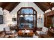 Cozy living room featuring a large window with a view, leather sofa, and stylish decor at 7225 Box Canyon Rd, Sedalia, CO 80135