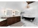 Luxurious main bathroom with a clawfoot tub, chandelier, and double vanity sinks at 7225 Box Canyon Rd, Sedalia, CO 80135