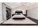 Spacious main bedroom with high ceilings, a large bed, and an exterior door at 7225 Box Canyon Rd, Sedalia, CO 80135
