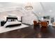Bright main bedroom featuring high ceilings, dark wood floors, and a cozy sitting area with a fireplace at 7225 Box Canyon Rd, Sedalia, CO 80135