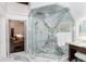Marble walk-in shower with glass enclosure, and a sitting area in the upscale bathroom at 7225 Box Canyon Rd, Sedalia, CO 80135