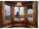 Charming sitting room with bay windows, wood trim, and a telescope to enjoy the view at 7225 Box Canyon Rd, Sedalia, CO 80135