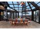 Bright sun room with beautiful views, floor to ceiling glass, and large dining table at 7225 Box Canyon Rd, Sedalia, CO 80135