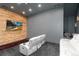 Home theater room with wood paneled wall, large TV, soft rug, and reclining couches at 7225 Box Canyon Rd, Sedalia, CO 80135