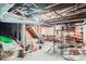Unfinished basement with exposed ceiling, wine rack, and storage shelves at 3356 Quivas St, Denver, CO 80211