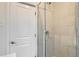 Bathroom with a glass shower door, tiled shower, and white trim at 3356 Quivas St, Denver, CO 80211