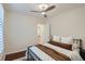 Neutral bedroom with hardwood floors, ceiling fan, and a view into the hall at 3356 Quivas St, Denver, CO 80211