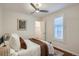 Bedroom features hardwood floors, a ceiling fan, and a window with shutter blinds at 3356 Quivas St, Denver, CO 80211
