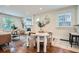 Cozy dining area with wood floors, a round table, and unique plush white chairs at 3356 Quivas St, Denver, CO 80211