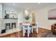 Open concept dining area with bar seating, wood floors, and bright natural light at 3356 Quivas St, Denver, CO 80211