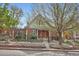 Charming brick home featuring a wrought iron fence and a mature shade tree in the front yard at 3356 Quivas St, Denver, CO 80211