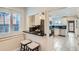 Eat-in bar overlooking an updated kitchen with stainless steel appliances and tile flooring at 3356 Quivas St, Denver, CO 80211