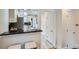 Eat-in bar overlooking an updated kitchen with stainless steel appliances and tile flooring at 3356 Quivas St, Denver, CO 80211