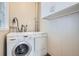 Modern laundry room featuring a Bosch washer and dryer with white cabinets at 3356 Quivas St, Denver, CO 80211