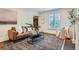 Bright living room featuring a leather sofa, area rug, and modern decor at 3356 Quivas St, Denver, CO 80211