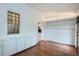 Living room featuring hardwood floors, built in storage, and glass block window at 3356 Quivas St, Denver, CO 80211