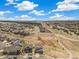 Aerial view of a neighborhood with houses, streets, and open spaces on a sunny day at 24222 E Canyon Pl, Aurora, CO 80016