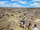 Aerial view showing homes with solar panels nestled in a suburban community at 24222 E Canyon Pl, Aurora, CO 80016