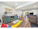 Finished basement with a wet bar, sink, and open layout leading to an outdoor patio area at 24222 E Canyon Pl, Aurora, CO 80016