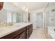 Bathroom featuring double sinks, a large mirror, and a glass-enclosed shower at 24222 E Canyon Pl, Aurora, CO 80016