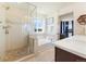 Bright bathroom featuring a glass shower, soaking tub and double vanity with modern finishes at 24222 E Canyon Pl, Aurora, CO 80016