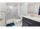 Bathroom features blue and white tiles in the shower with blue vanity and updated fixtures at 24222 E Canyon Pl, Aurora, CO 80016