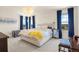 Bright bedroom featuring a large bed, modern decor, and view to the horizon through the windows at 24222 E Canyon Pl, Aurora, CO 80016