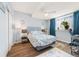 Bright bedroom featuring hardwood floors, a queen-sized bed, and a ceiling fan at 24222 E Canyon Pl, Aurora, CO 80016
