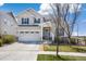 Charming two-story home boasts a two-car garage, stone accents, and a well-manicured lawn in a desirable neighborhood at 24222 E Canyon Pl, Aurora, CO 80016