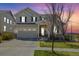 Charming two-story home boasts beautiful stone accents, a well-manicured lawn, and a two-car garage at 24222 E Canyon Pl, Aurora, CO 80016