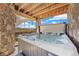 Covered hot tub area with stone pillars creates a private outdoor spa at 24222 E Canyon Pl, Aurora, CO 80016