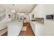 Well-lit kitchen with stainless steel appliances, white cabinets, and gray subway tile backsplash at 24222 E Canyon Pl, Aurora, CO 80016