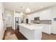 Bright kitchen features white cabinets, stainless steel appliances, and a large center island at 24222 E Canyon Pl, Aurora, CO 80016