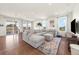 Bright and spacious living room with a large sofa and hardwood floors at 24222 E Canyon Pl, Aurora, CO 80016