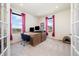 Bright office space features a large window, a work space, and plush carpet at 24222 E Canyon Pl, Aurora, CO 80016