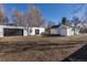 Wide view of the backyard, showing the detached garage, shed, and yard at 1435 Jay St, Lakewood, CO 80214