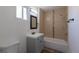 Updated bathroom featuring a shower-tub combo with tiled walls and a modern vanity at 1435 Jay St, Lakewood, CO 80214
